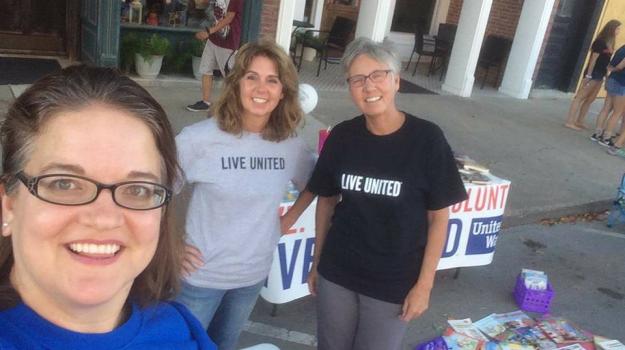 Veronica Ohler, President of the United Way Board, Missy Koning, Secretary of the Board and Patti Becker, Administrative Director of the United Way of Logan County get ready to pass out books! 